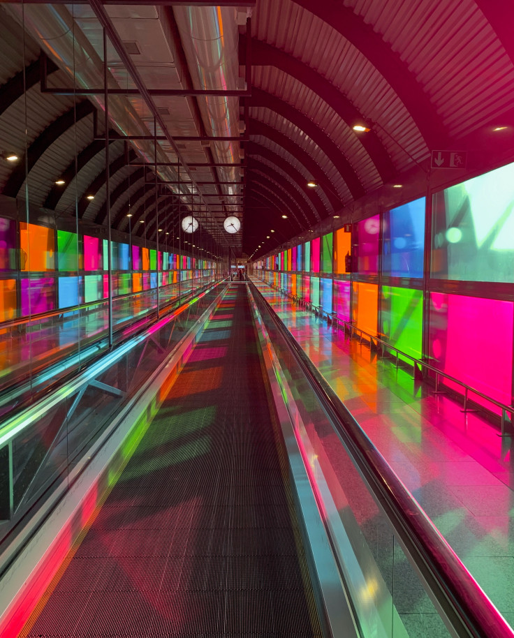 Walkway surrounded by pink, green, orange and blue windows in Madrid