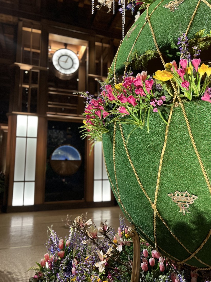 Hotel lobby with a large green sphere decorated with flowers