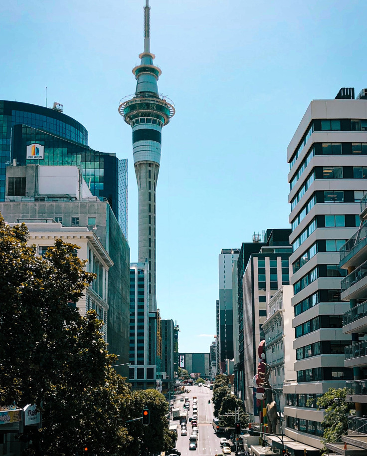 City with buildings and road with cars with clear skies during daytime