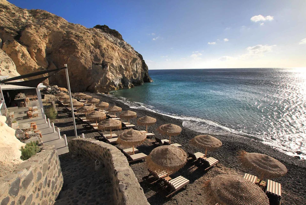 Akro beach bar is a secret black pebble beach.