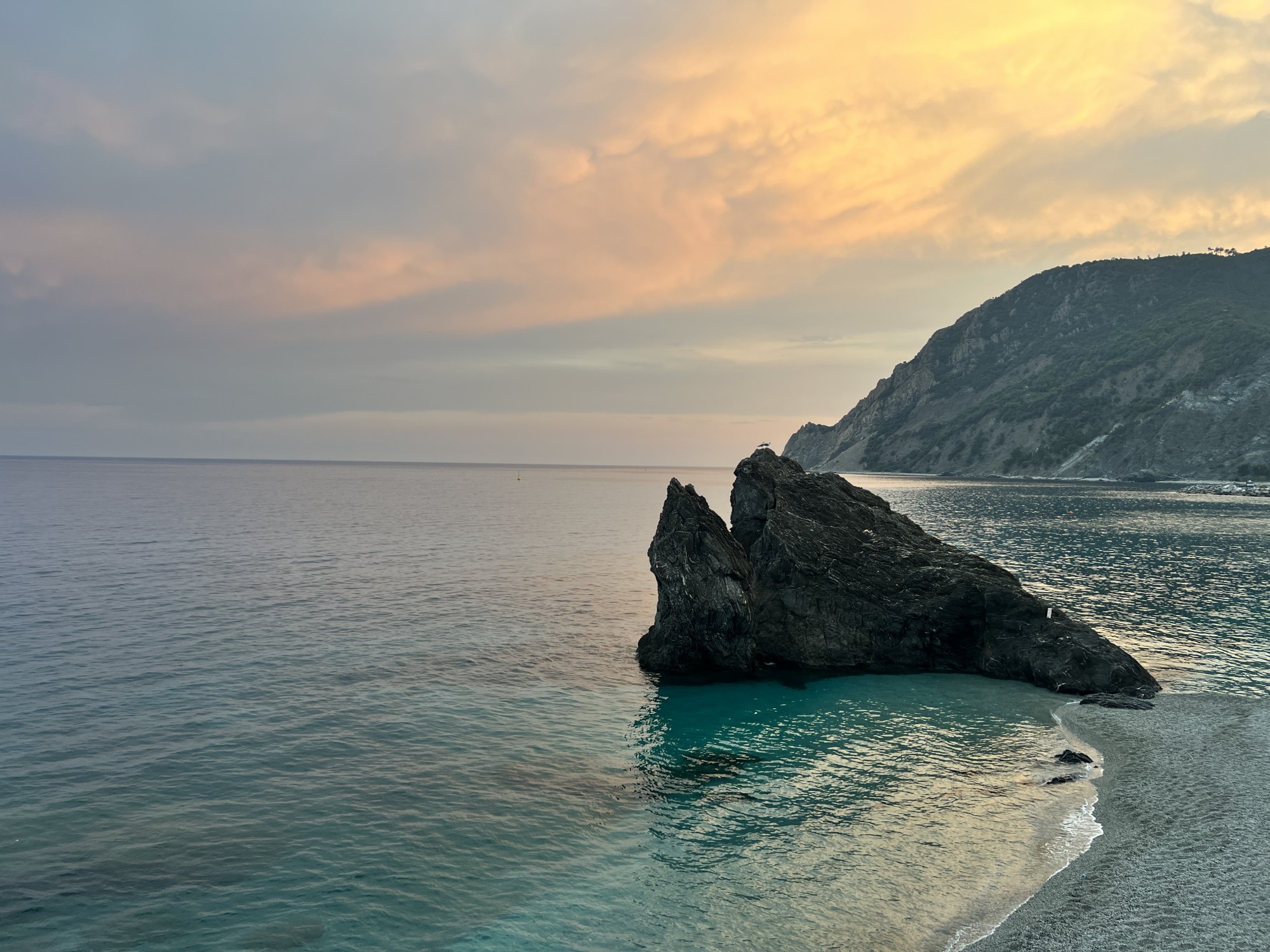 A rock in the sea on beach. 