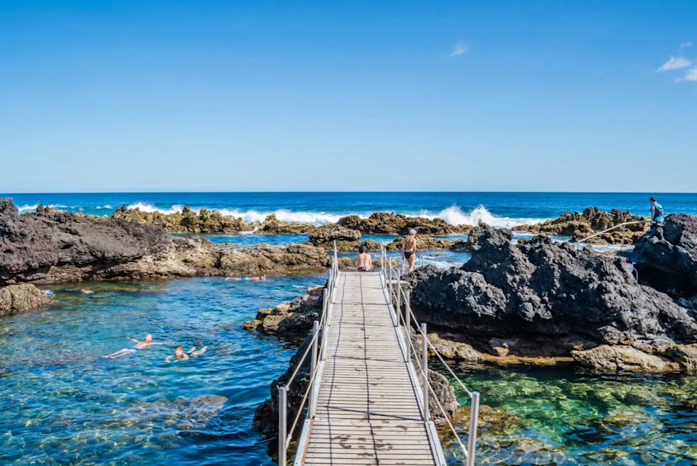 A natural pool with a wooden walkway in the Azores.