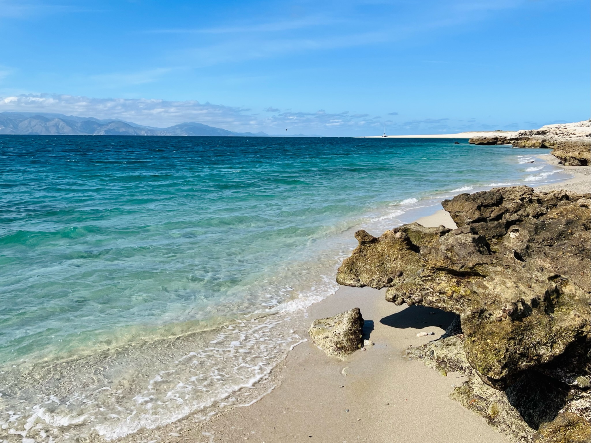 rocky coastline next to ocean during daytime