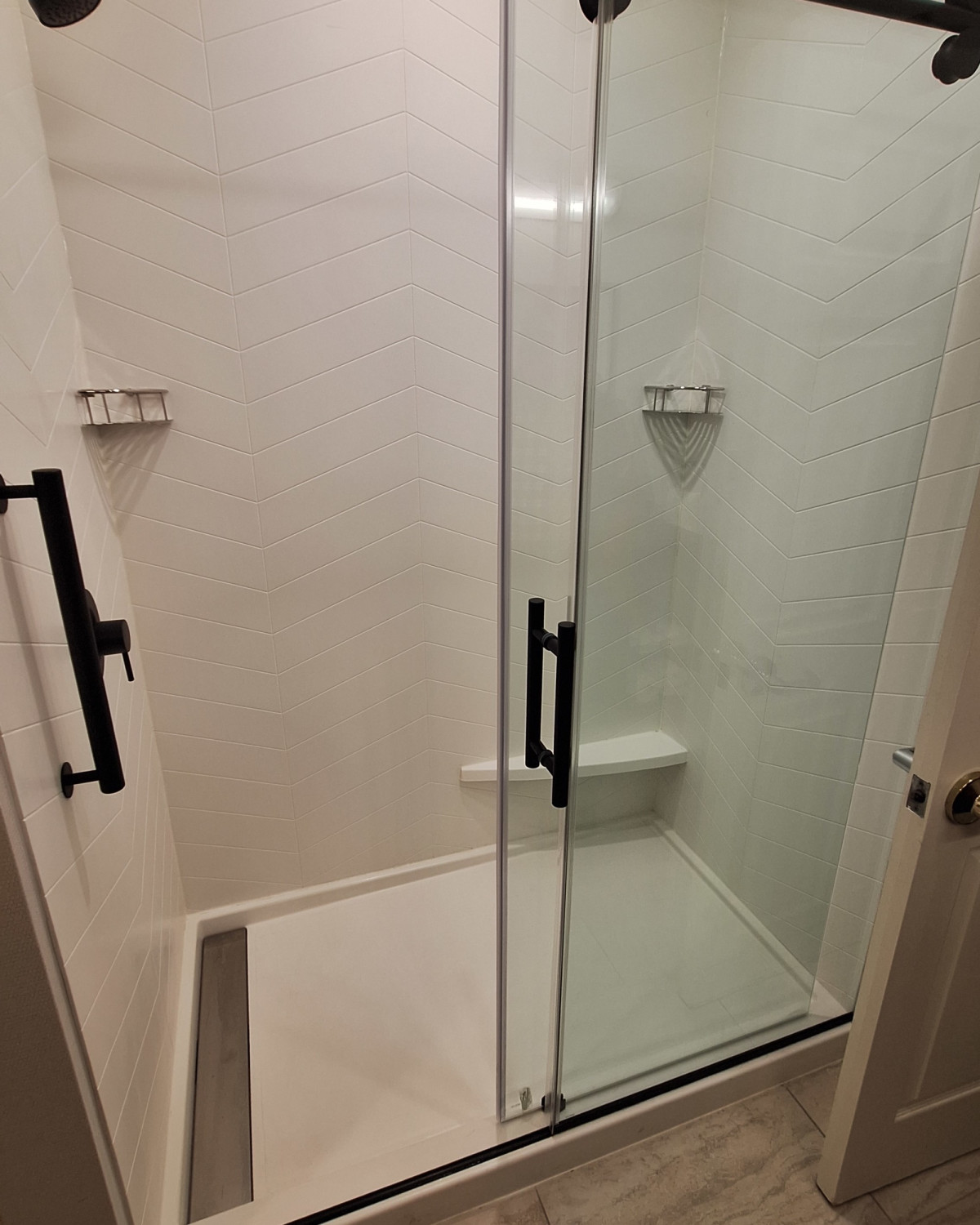 A photo of a shower with a glass door