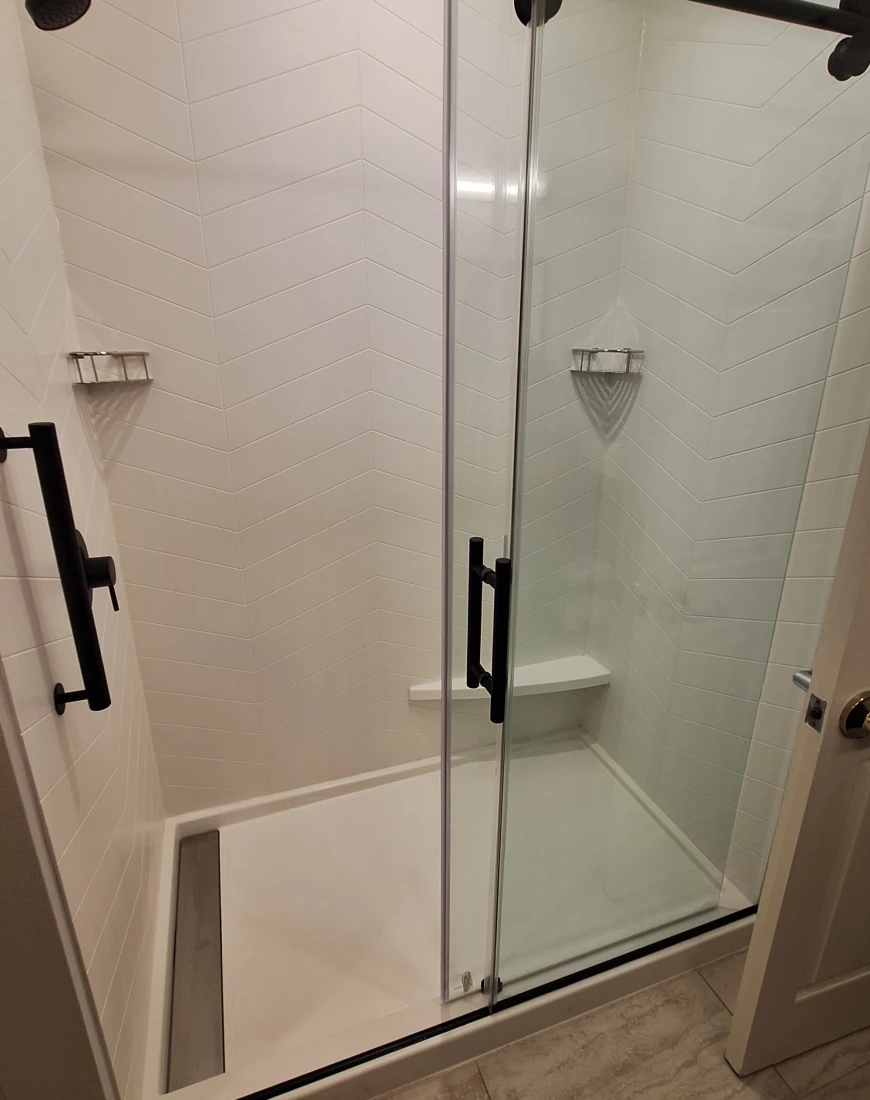 A photo of a shower with a glass door