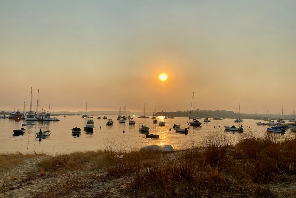 Sunset view at the beach and boats in the water