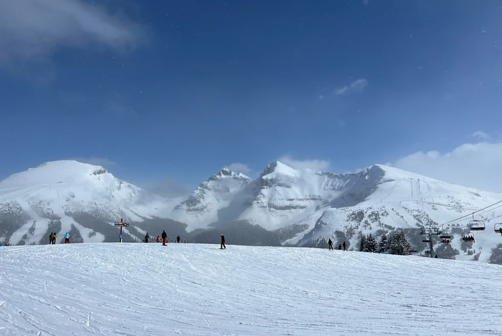 snowy ski slopes with mountain range