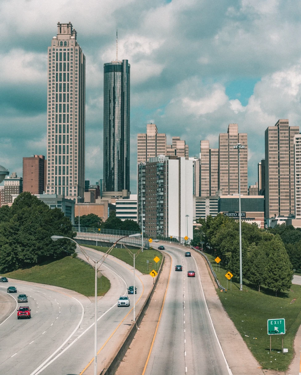 Aerial view of city buildings with highway during daytime.