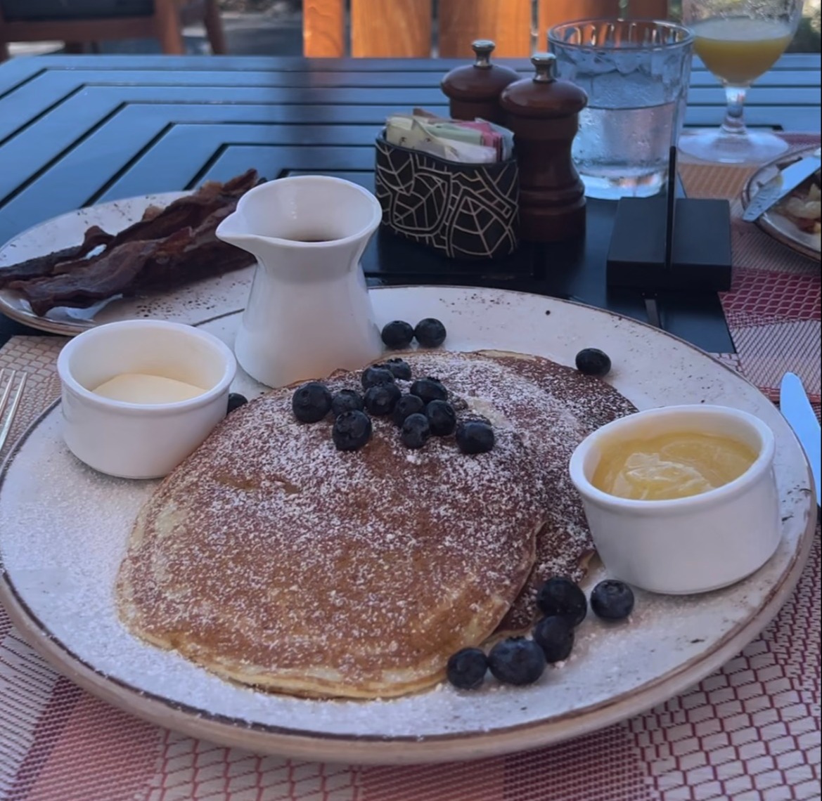 plate of pancakes with butter with views of the ocean