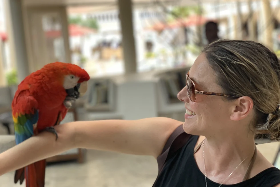 Travel advisor Kelly Weber with a bird on her arm.