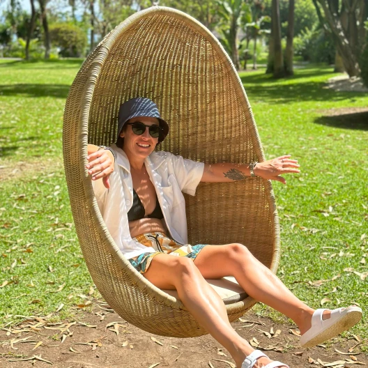 Travel advisor posing in a swing