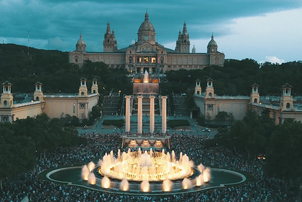 fountains in front of a domed building at night