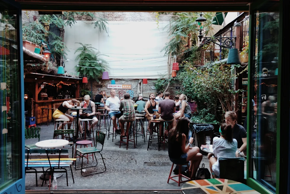 large window with people sitting in a garden