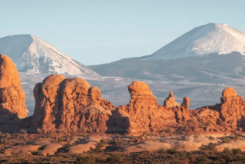 Brown rocky formations under blue sky during daytime.
