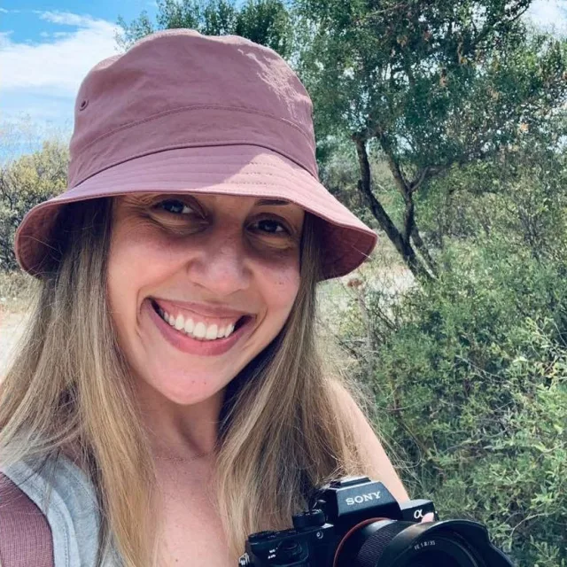 Travel advisor Dina smiling and holding camera