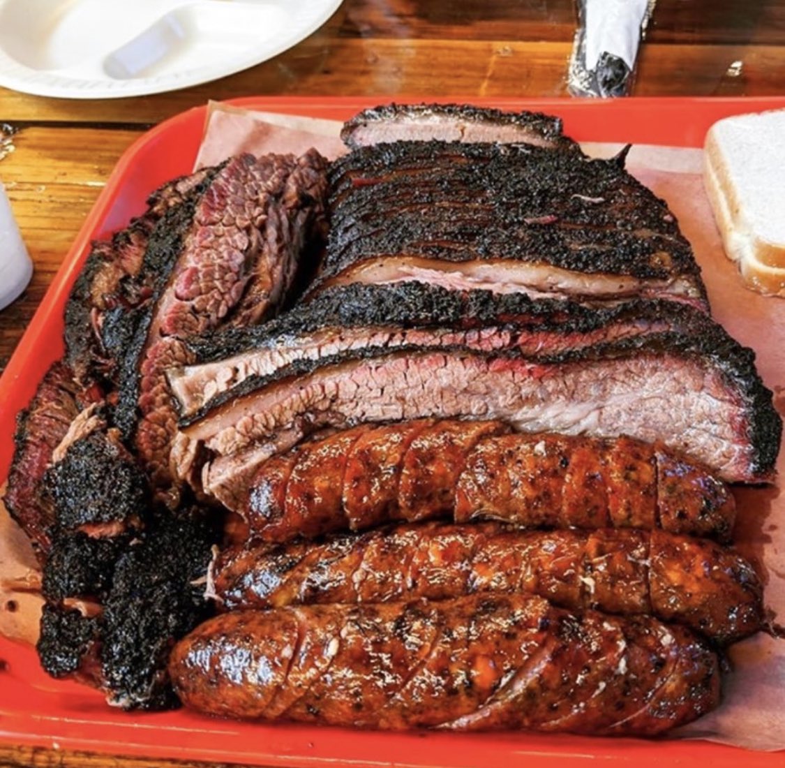Barbecued meats on a red plate 