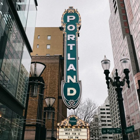 vertical green sign that reads "Portland"