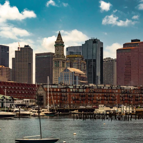 Body of water with buildings on a sunny day during daytime