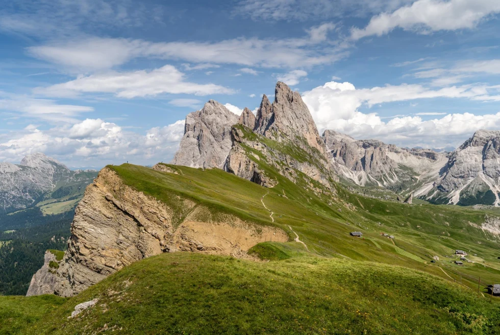 Green Grass Field And Mountain Under Blue Sky
