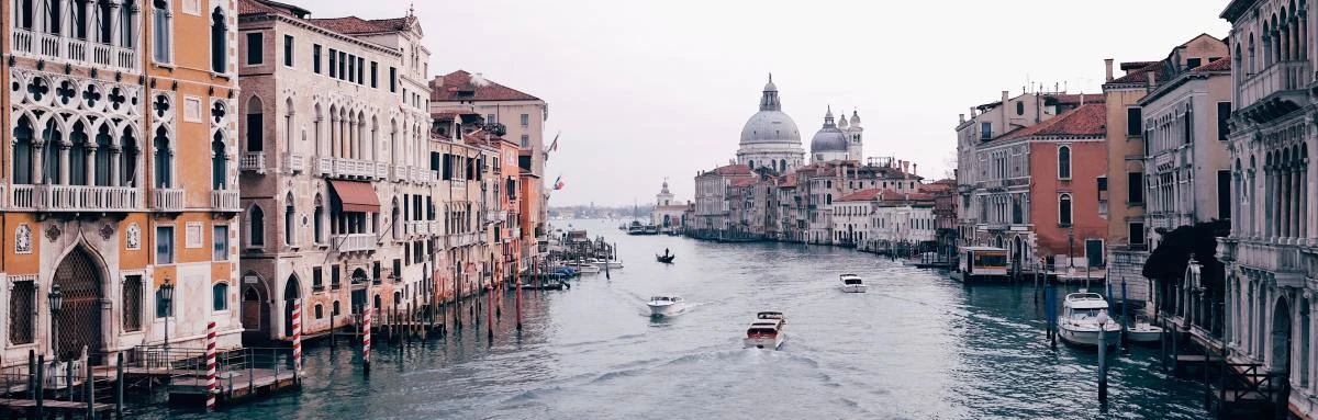 Gondolas rowing through canals of Venice, Italy. 