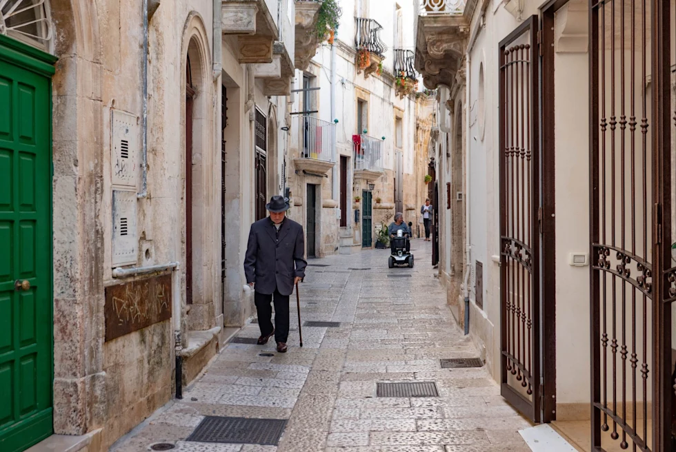 white stucco city walls in a narrow street