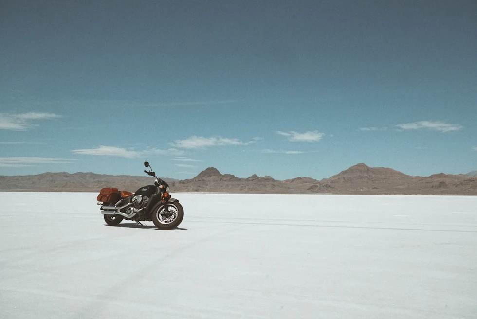 motorcycle on a large salt flat during daytime