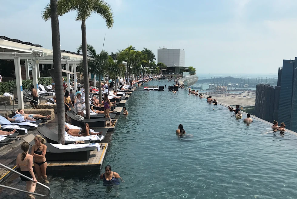 people in pool overlooking the city