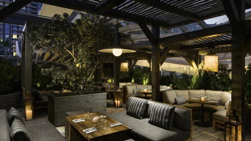 cozy dining area amid wooden beams and foliage