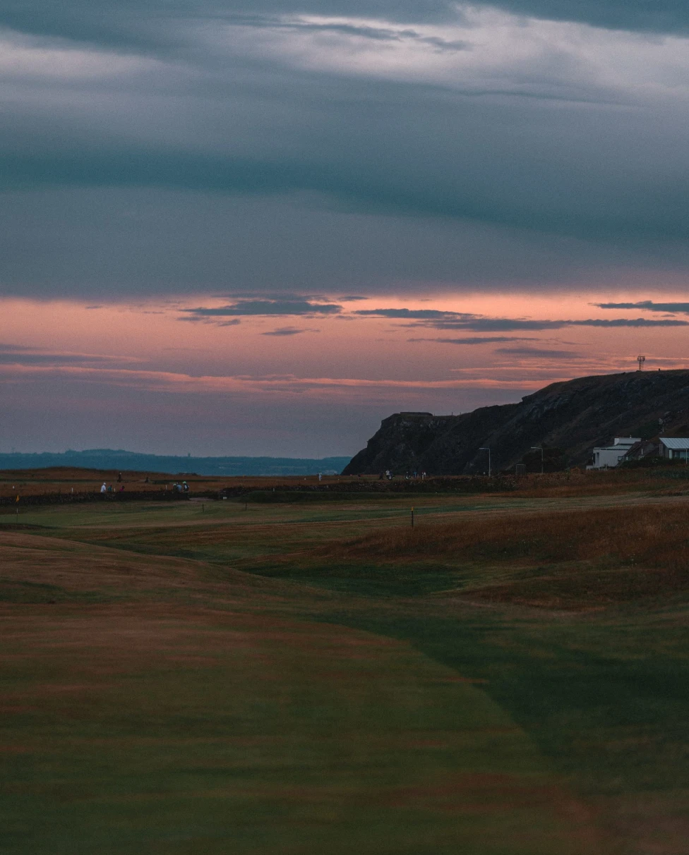 golf course on coast at pink sunset