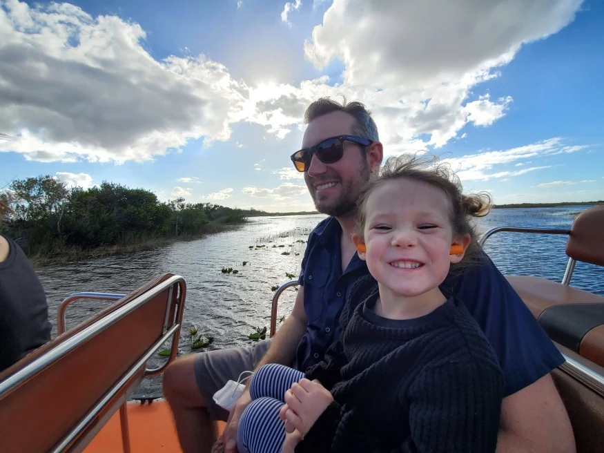 A dad on a boat with his daughter.