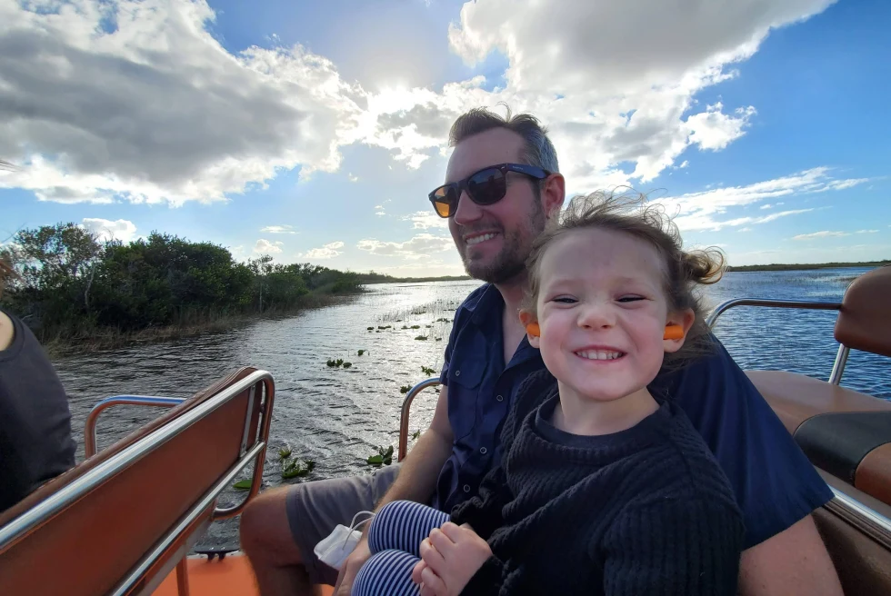 A dad on a boat with his daughter.