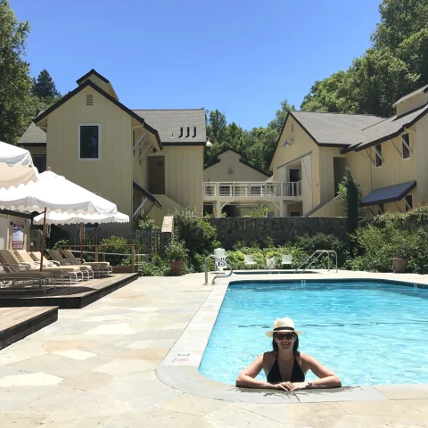 Travel advisor posing in a pool