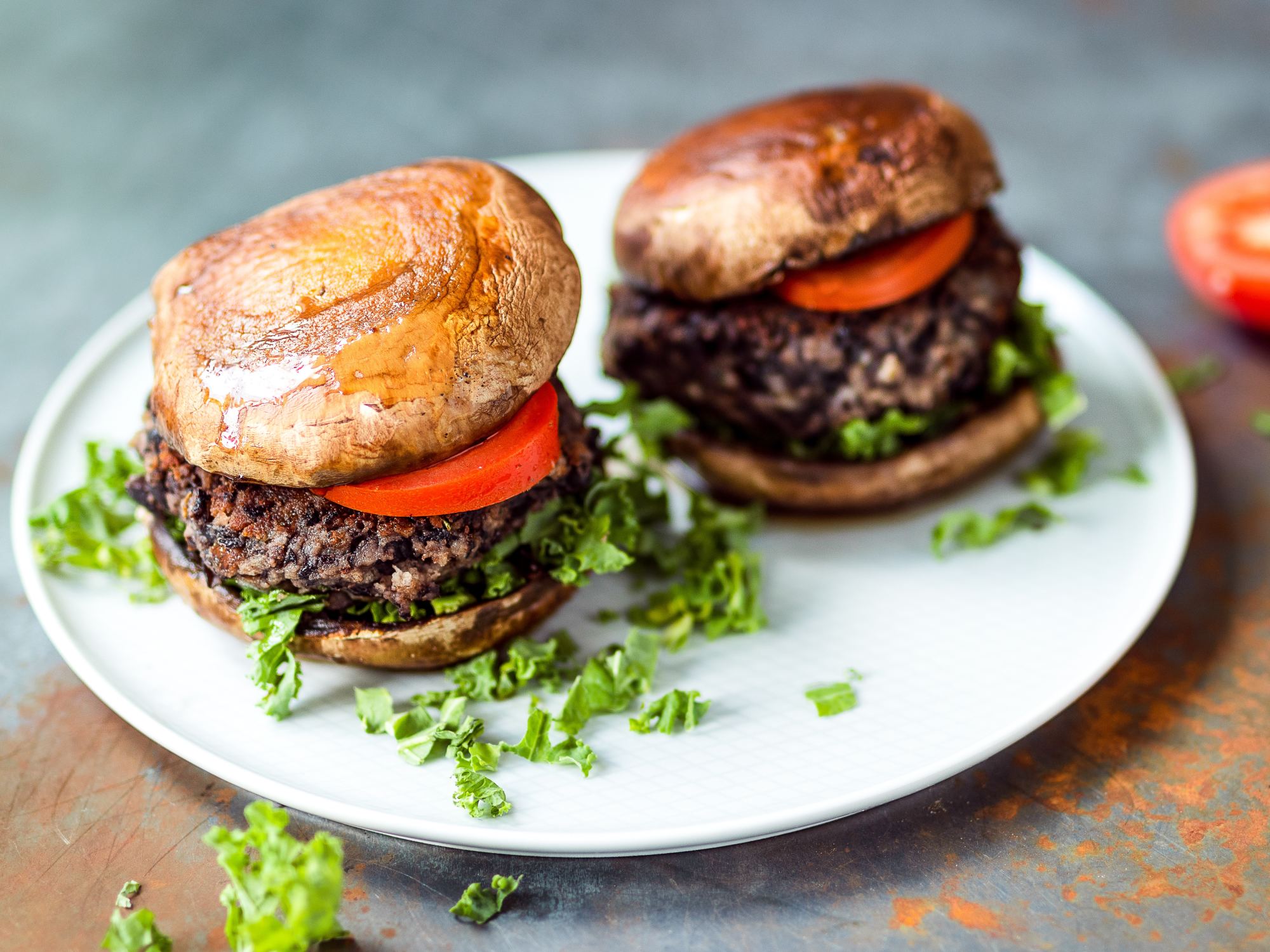 Two small burgers on a white plate