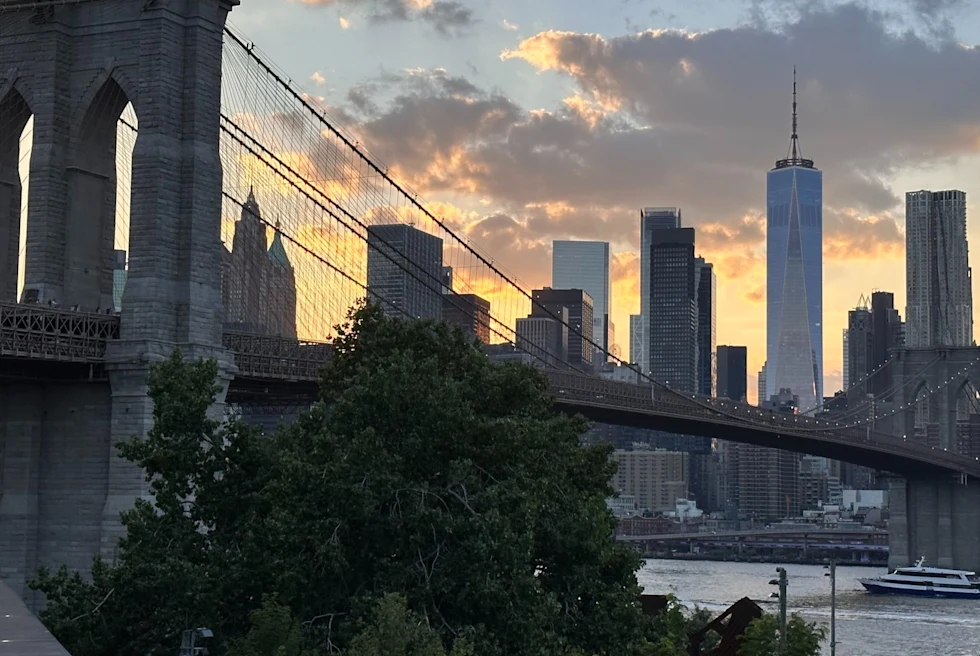 City skyline behind a bridge.