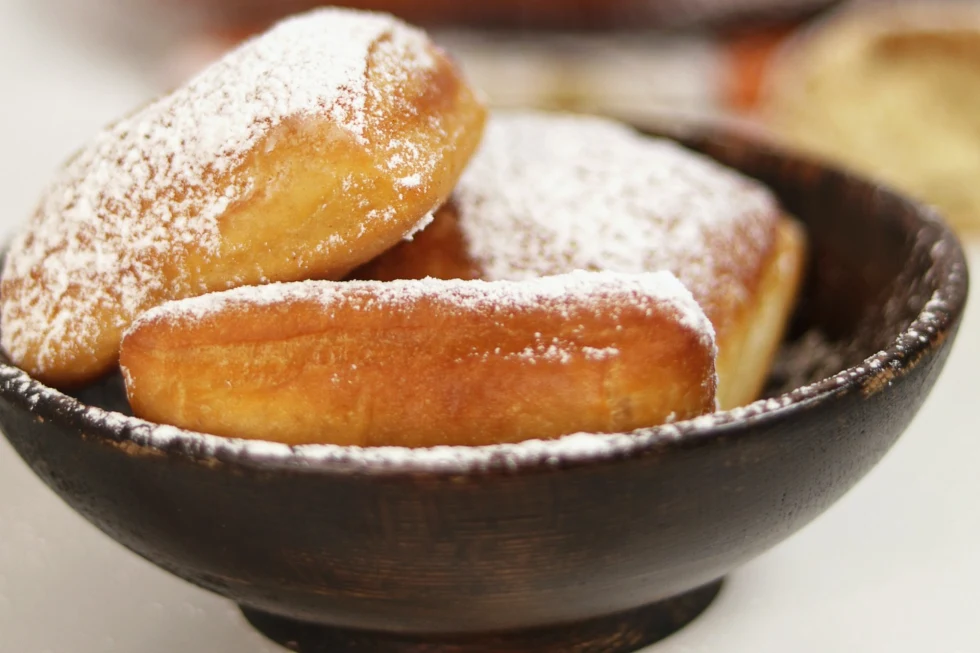close-up of powder sugar-covered donuts