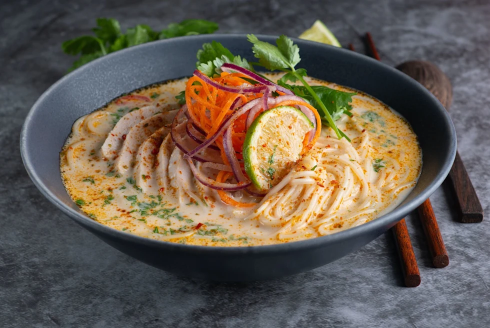 Thai red curry noodle soup with chicken.