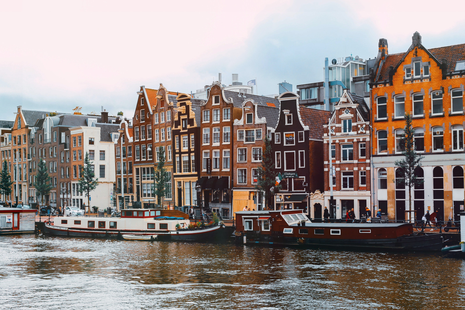 boats in the water next to colorful buildings