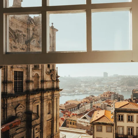 window overlooking buildings and body of water