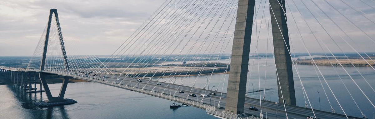 Steel bridge crossing deep blue bay in South Carolina.