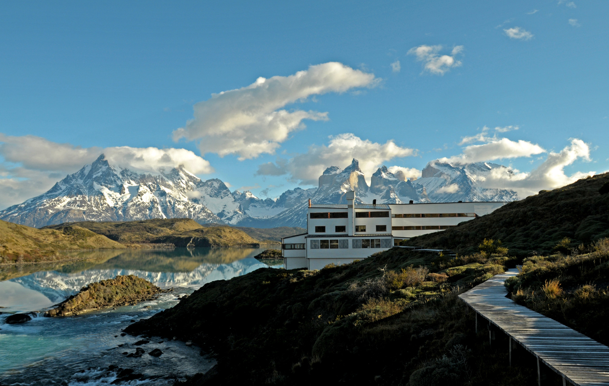 dramatic mountain peaks and blue sky with a white building