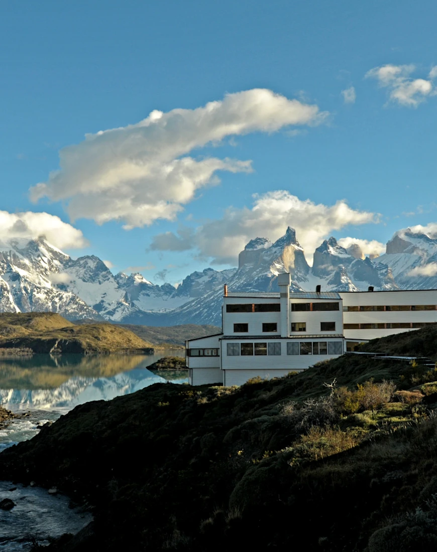 dramatic mountain peaks and blue sky with a white building