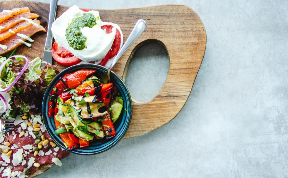 Vegetales and other greek food on a platter. 