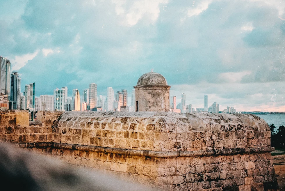 Cartagena in the evening with modern buildings peeking in the back.