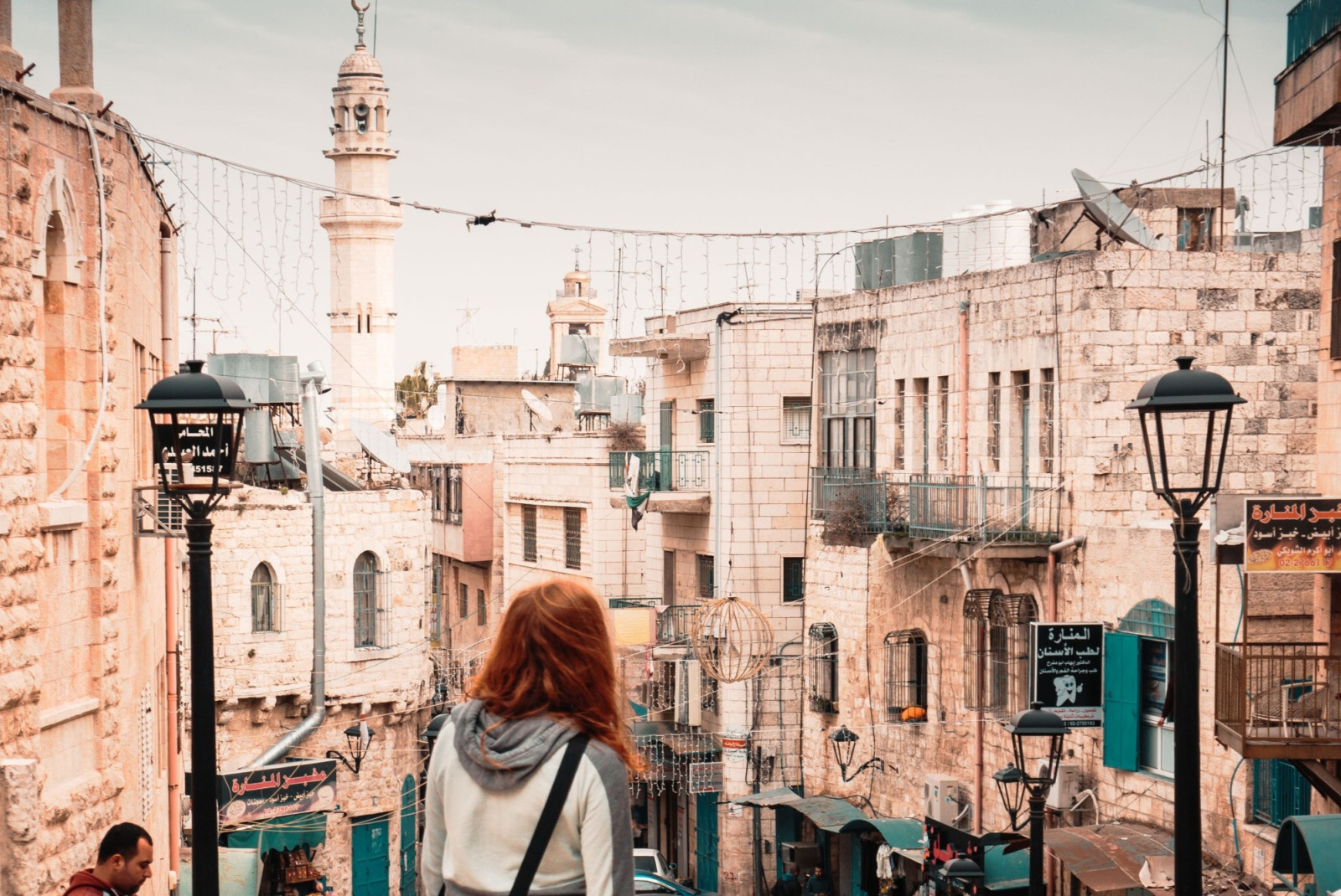 Girl staring from hilltop in the ancient city of Bethlehem on a bright day.