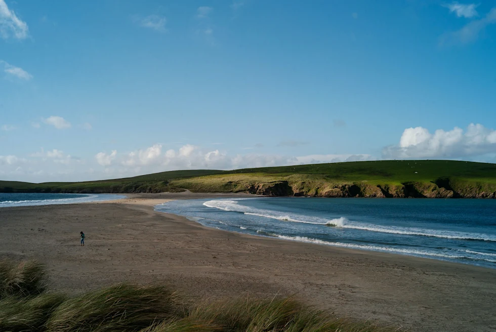body of water next to beach during daytime
