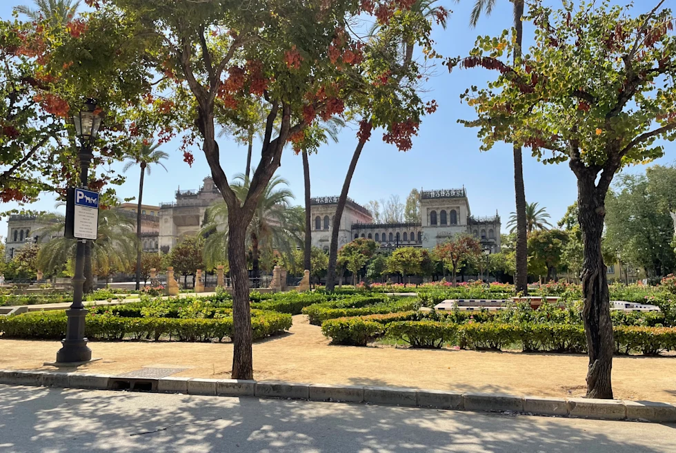 gardens next to a building with sunny skies