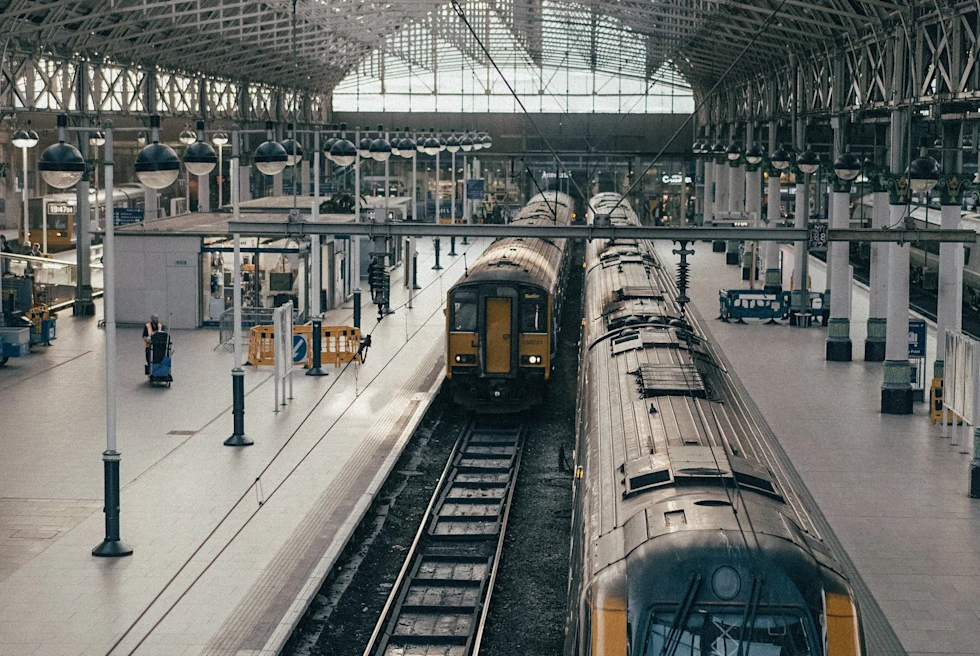 two yellow trains in building during daytime