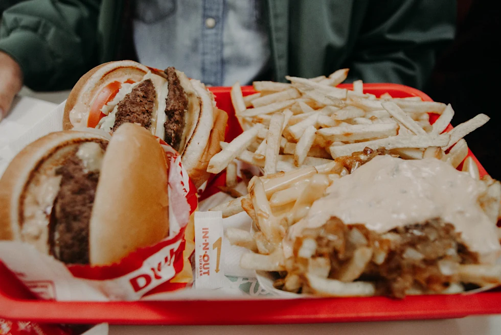 Red tray filled with burgers and fries