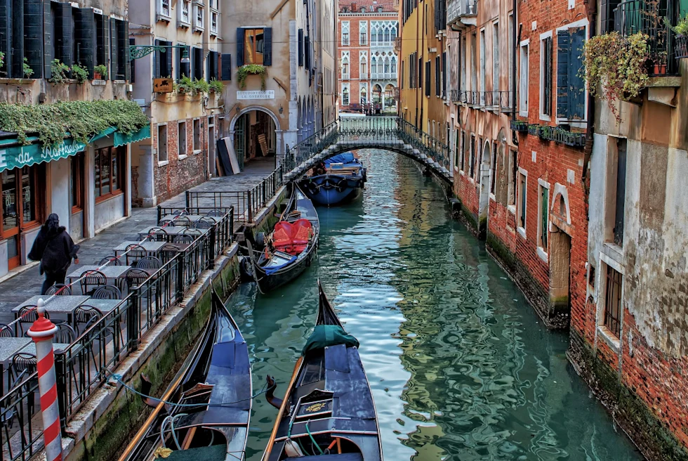 boats in a canal flanked by townhouses