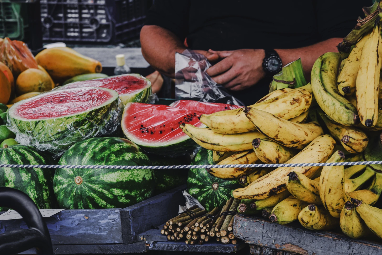 Bananas and watermelon at a fruit stand during daytime
